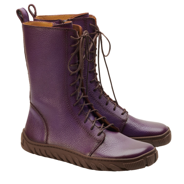 Wir präsentieren die DOQS Purple von ZAQQ, ein auffälliges Paar lilafarbener Schnürstiefel, fachmännisch aus hochwertigem Nappaleder gefertigt. Diese halbhohen Stiefel sind mit braunen Sohlen versehen und verfügen über eine strukturierte Oberfläche, die sowohl Stil als auch Substanz bietet. Vor einem sauberen weißen Hintergrund verfügen sie über eine ULTRAGRIP-Sohle, die für außergewöhnliche Traktion sorgt.